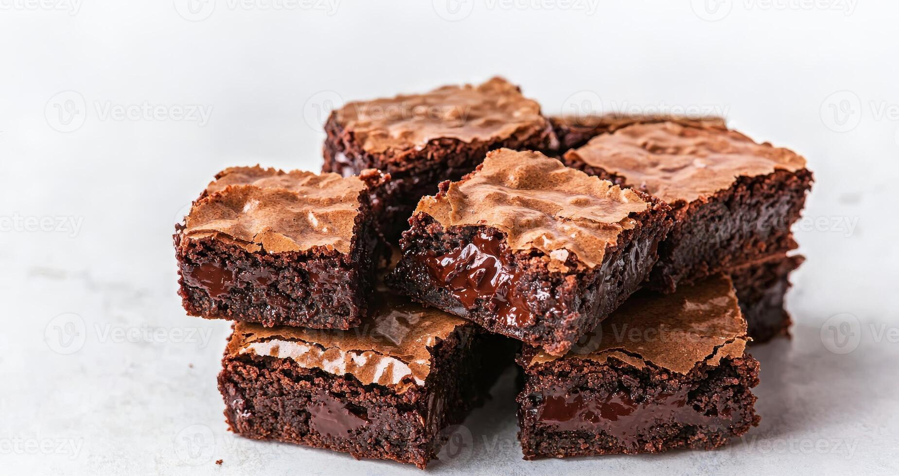 Rich brownie with chocolate chunks concept. A tempting stack of rich, fudgy brownies showcasing a glossy top and gooey interior, perfect for dessert lovers. photo