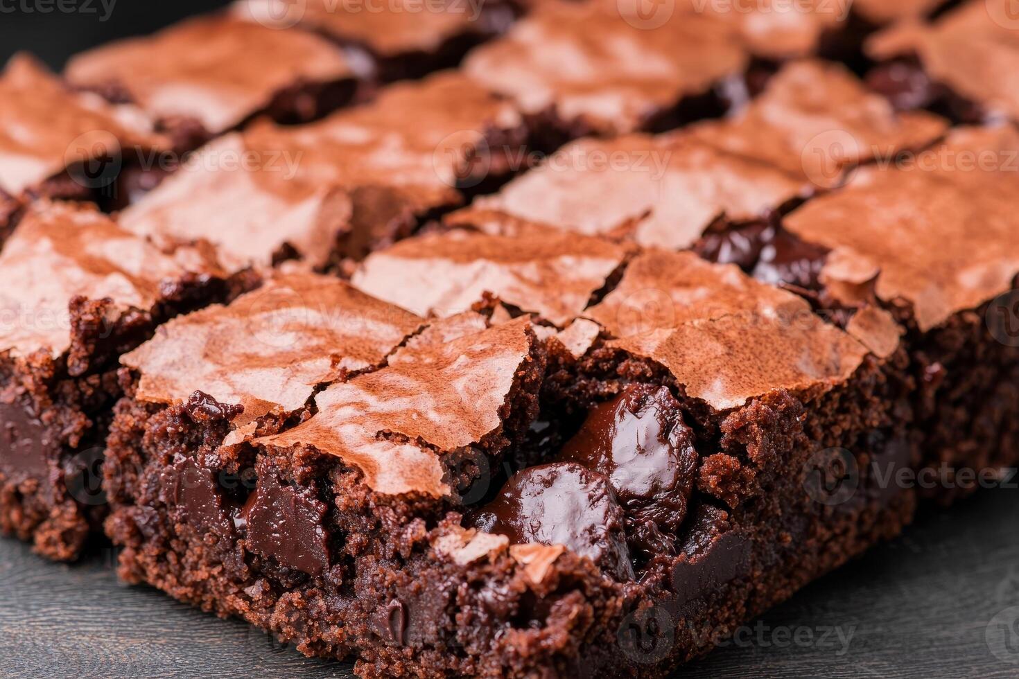 Rich brownie with chocolate chunks concept. A close-up of rich, fudgy brownies cut into squares, showcasing a glossy top and gooey chocolate chunks. photo