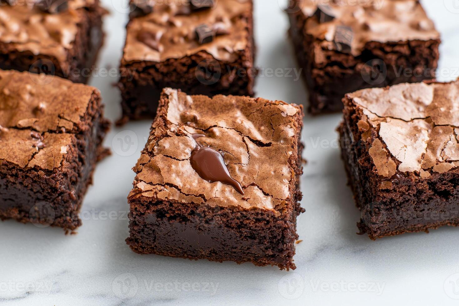 Rich brownie with chocolate chunks concept. Decadent chocolate brownies with a glossy top and fudgy texture, arranged neatly on a marble surface, inviting indulgence. photo