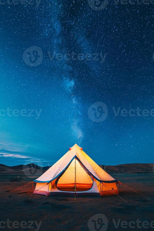 Adventure and Eco-tourism for travel concept. Glowing tent stands in the desert under a starry night sky, showcasing the beauty of nature and camping adventures. photo