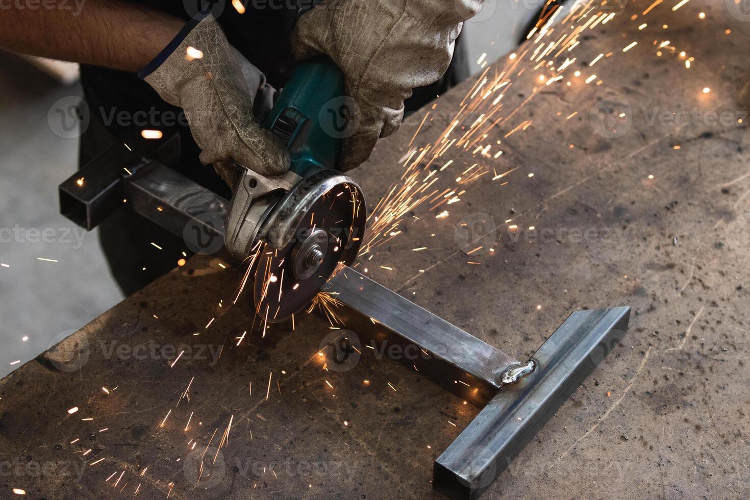 A person is grinding metal with a grinder photo
