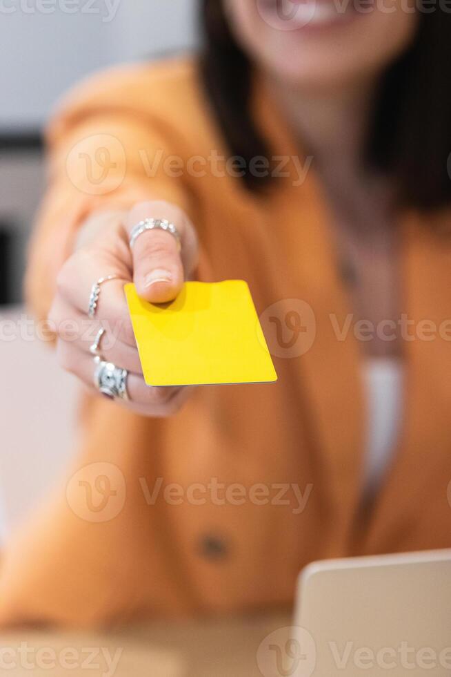 A woman holding a yellow card photo