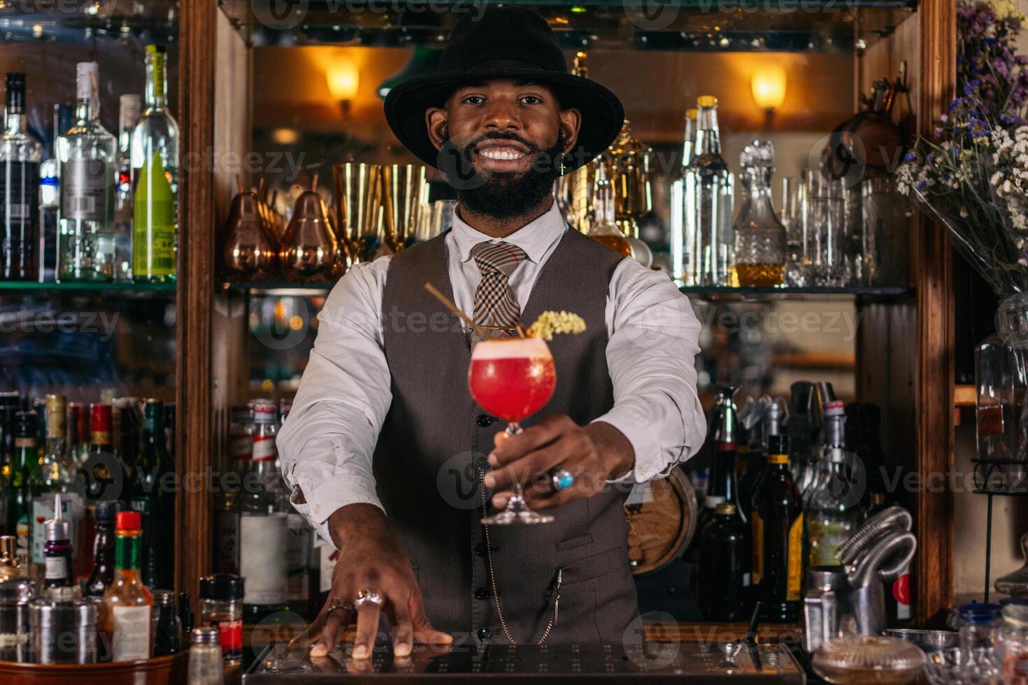A bartender with a drink in front of him photo