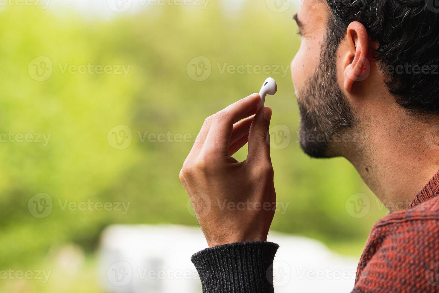 A man is brushing his teeth with a toothbrush photo