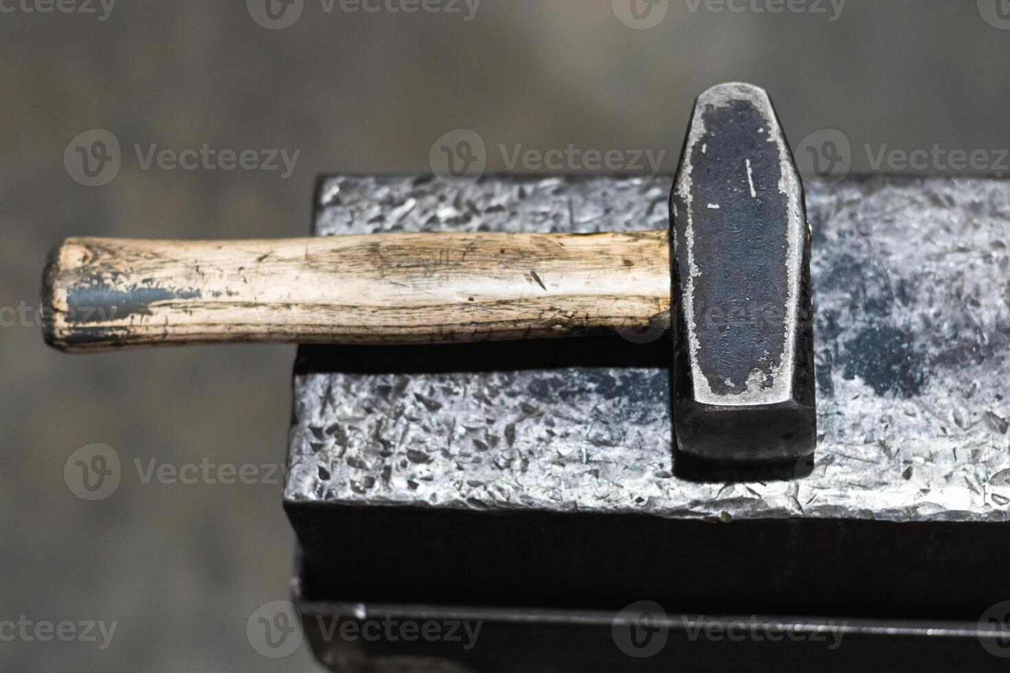 A hammer is sitting on top of a piece of metal photo