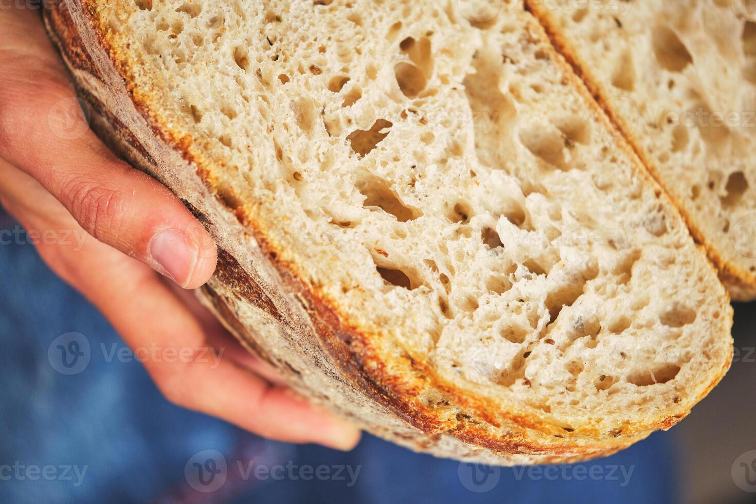 A person holding a loaf of bread photo
