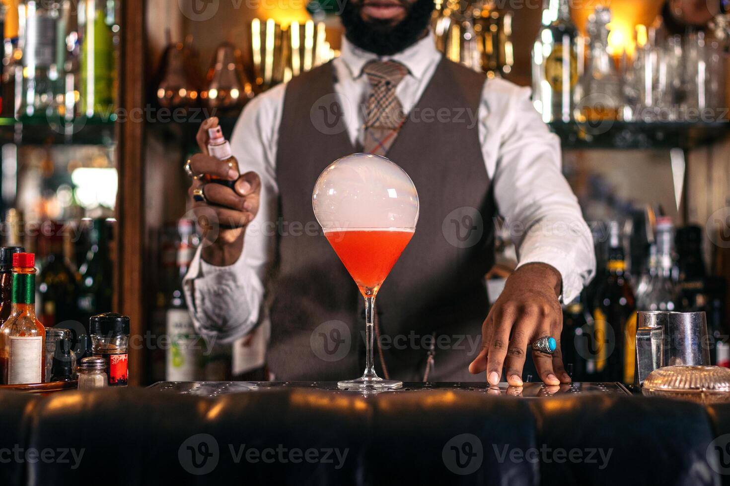 A bartender is making a cocktail photo