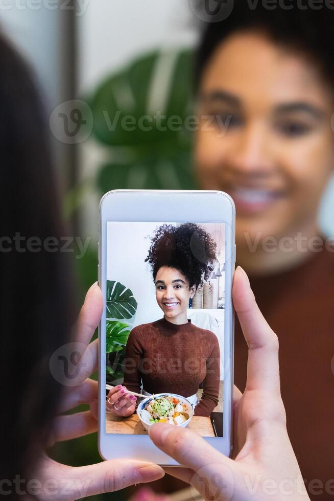 A woman taking a photo of herself with a phone