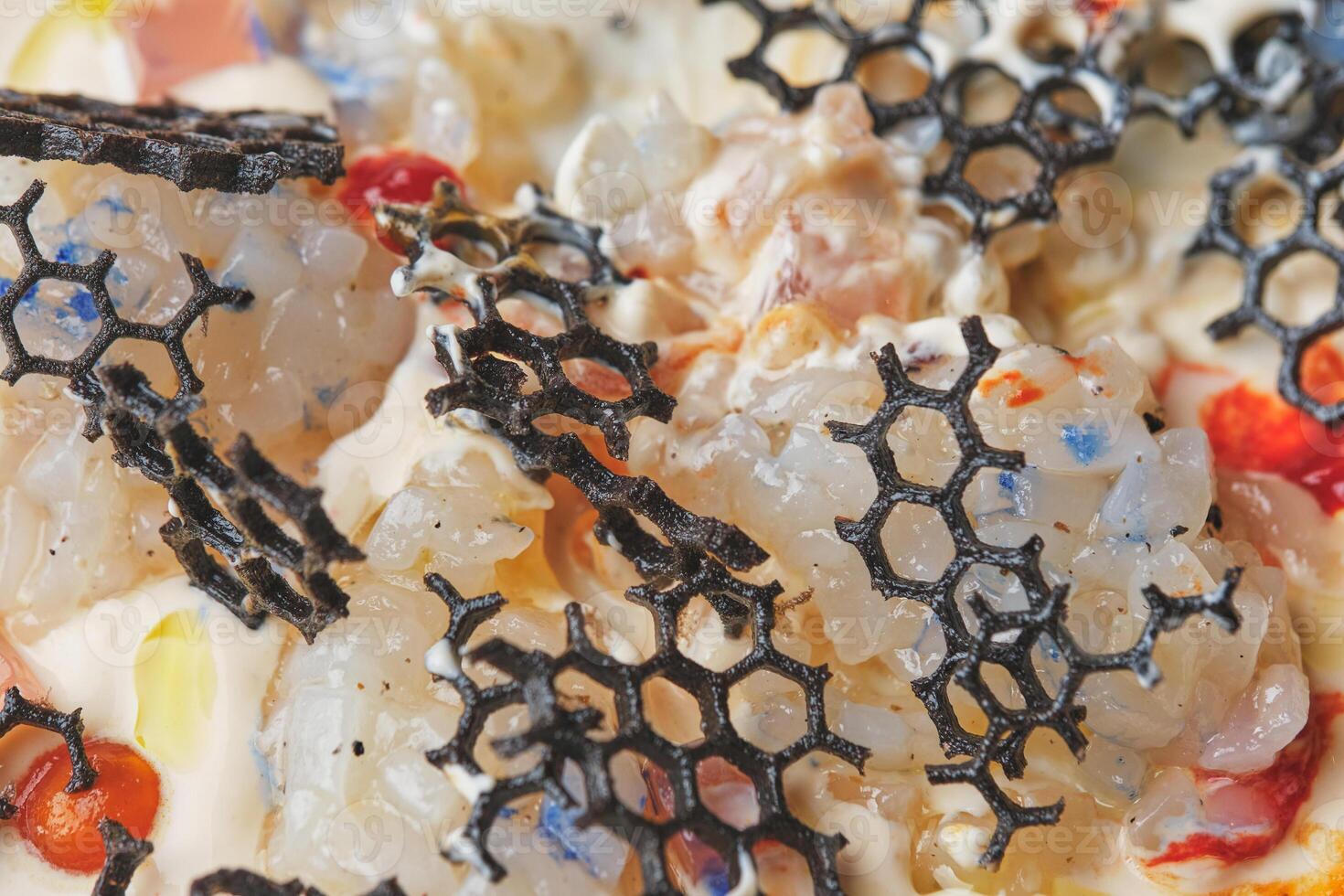 A pizza with honeycomb and other ingredients on top photo