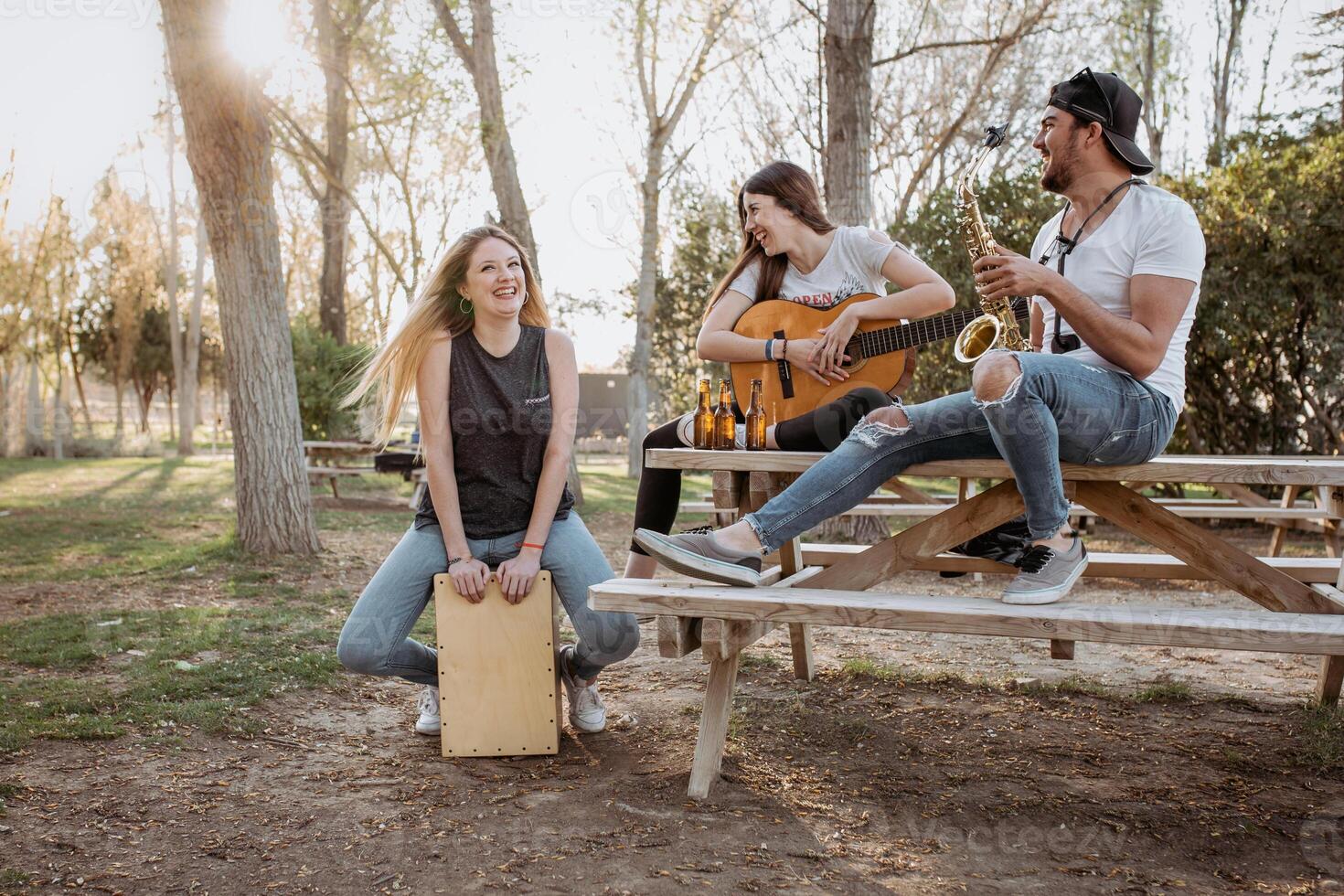 Cheerful musicians having fun in park photo