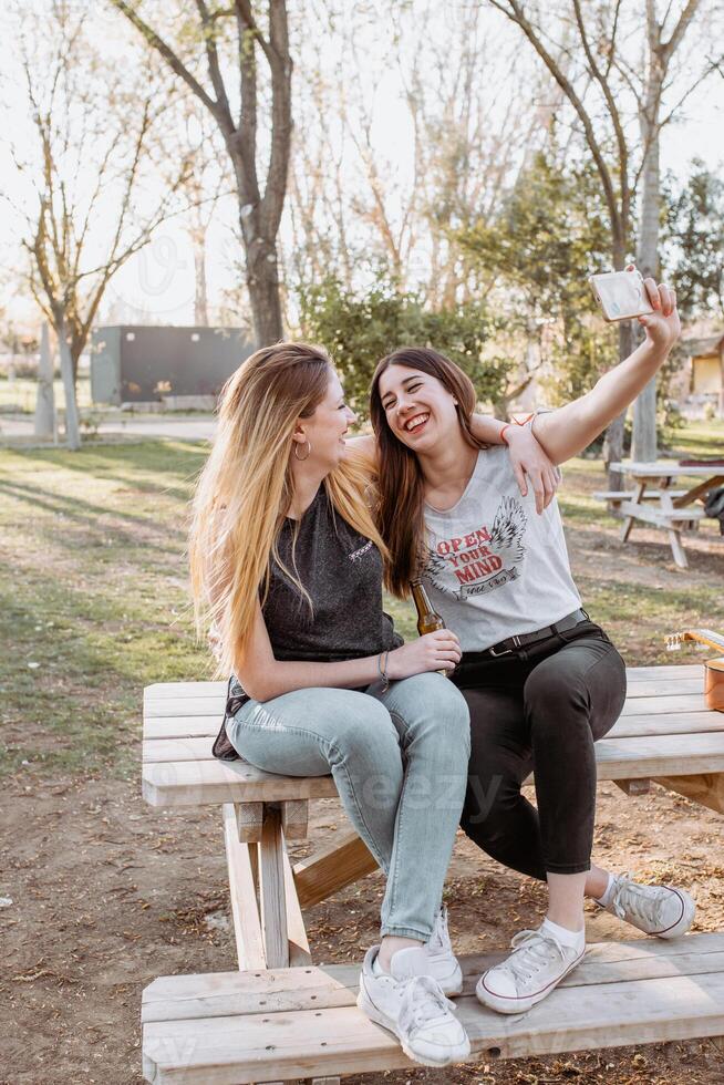 Smiling women taking selfie in park photo
