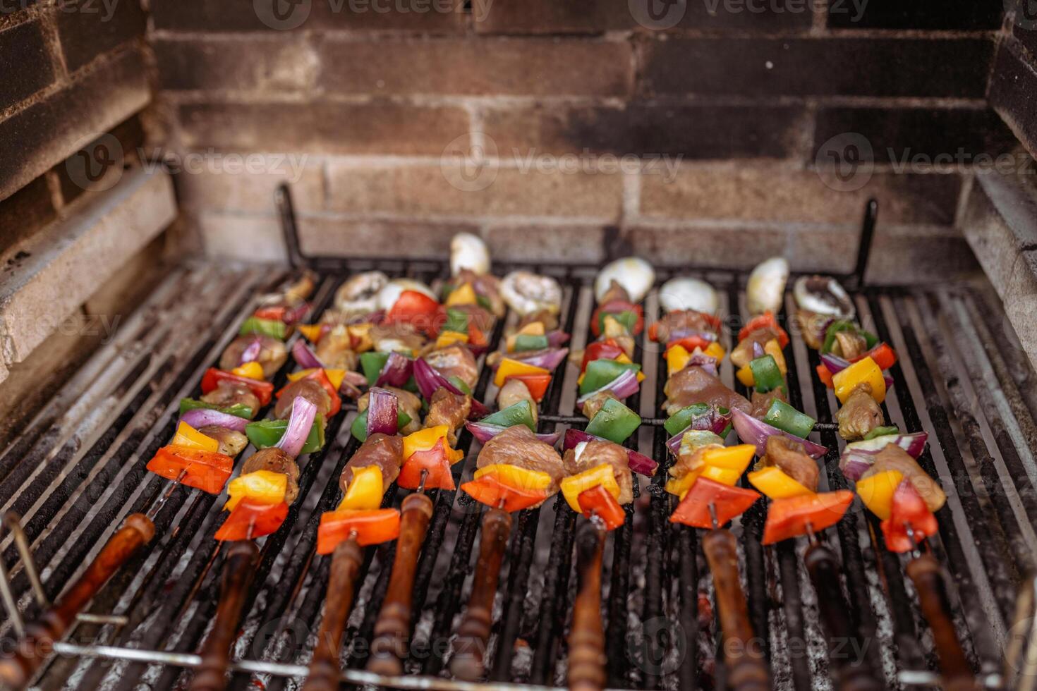 cooking skewers in barbecue photo
