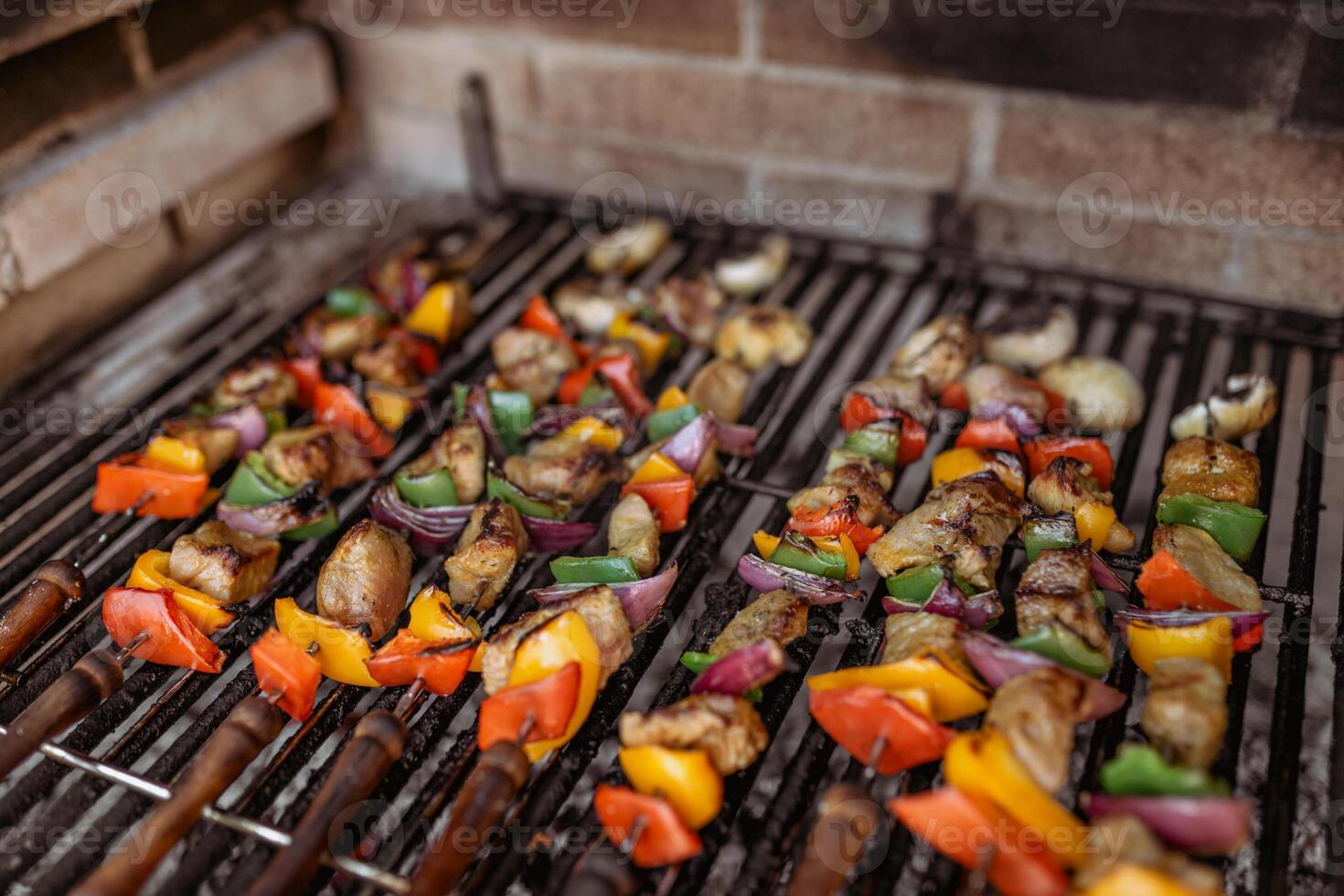 cooking skewers in barbecue photo