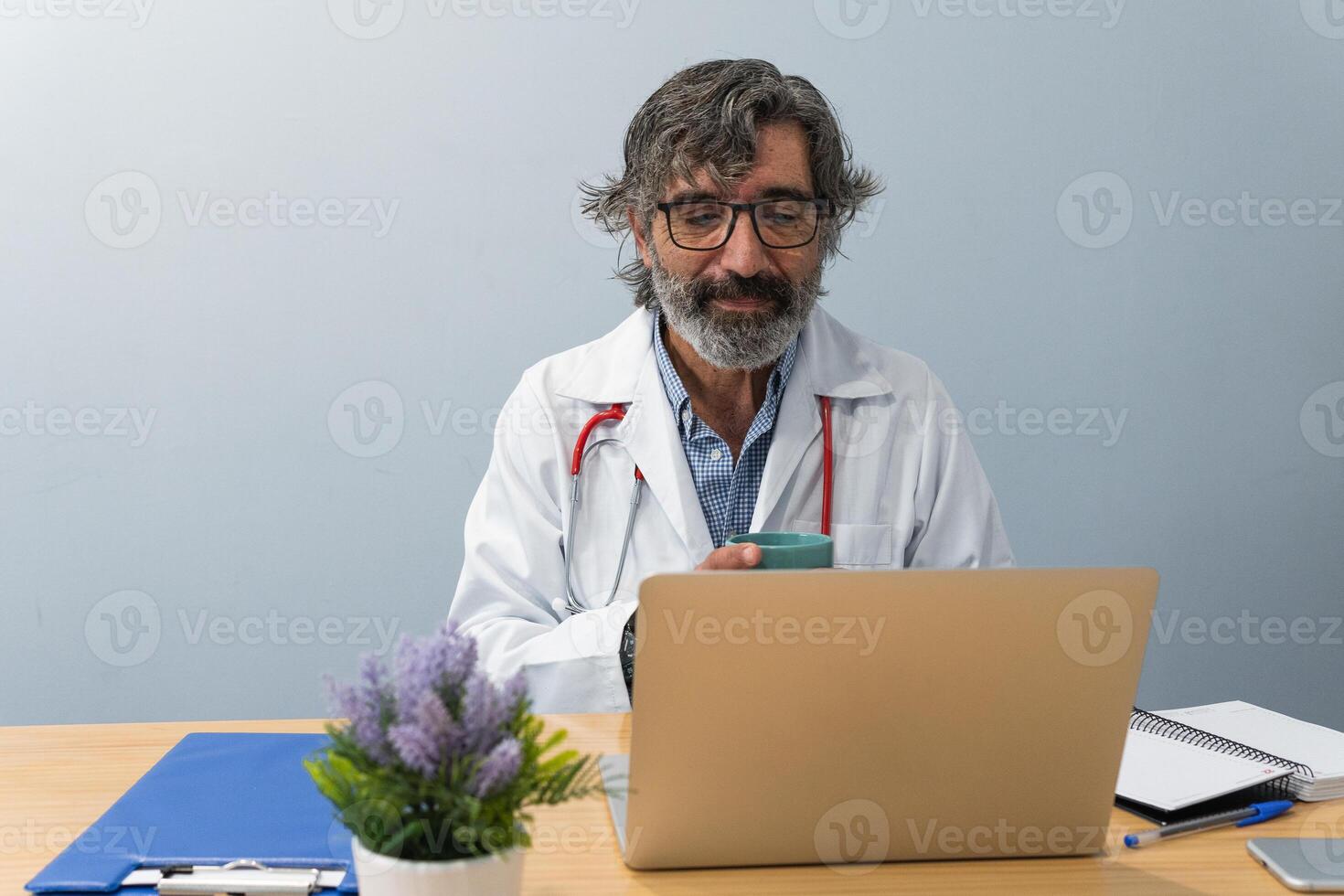 Elderly doctor talking to patient on chat photo