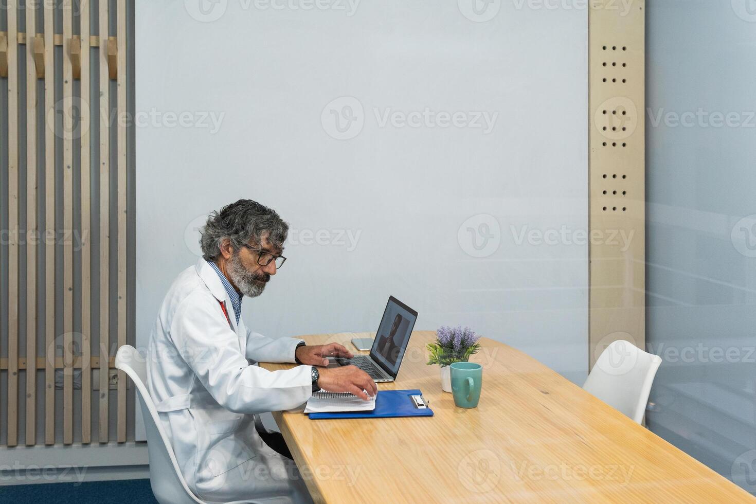Elderly doctor talking to patient on chat photo