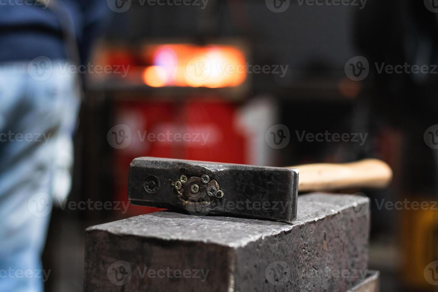 Hammer on workbench in blacksmith workshop photo