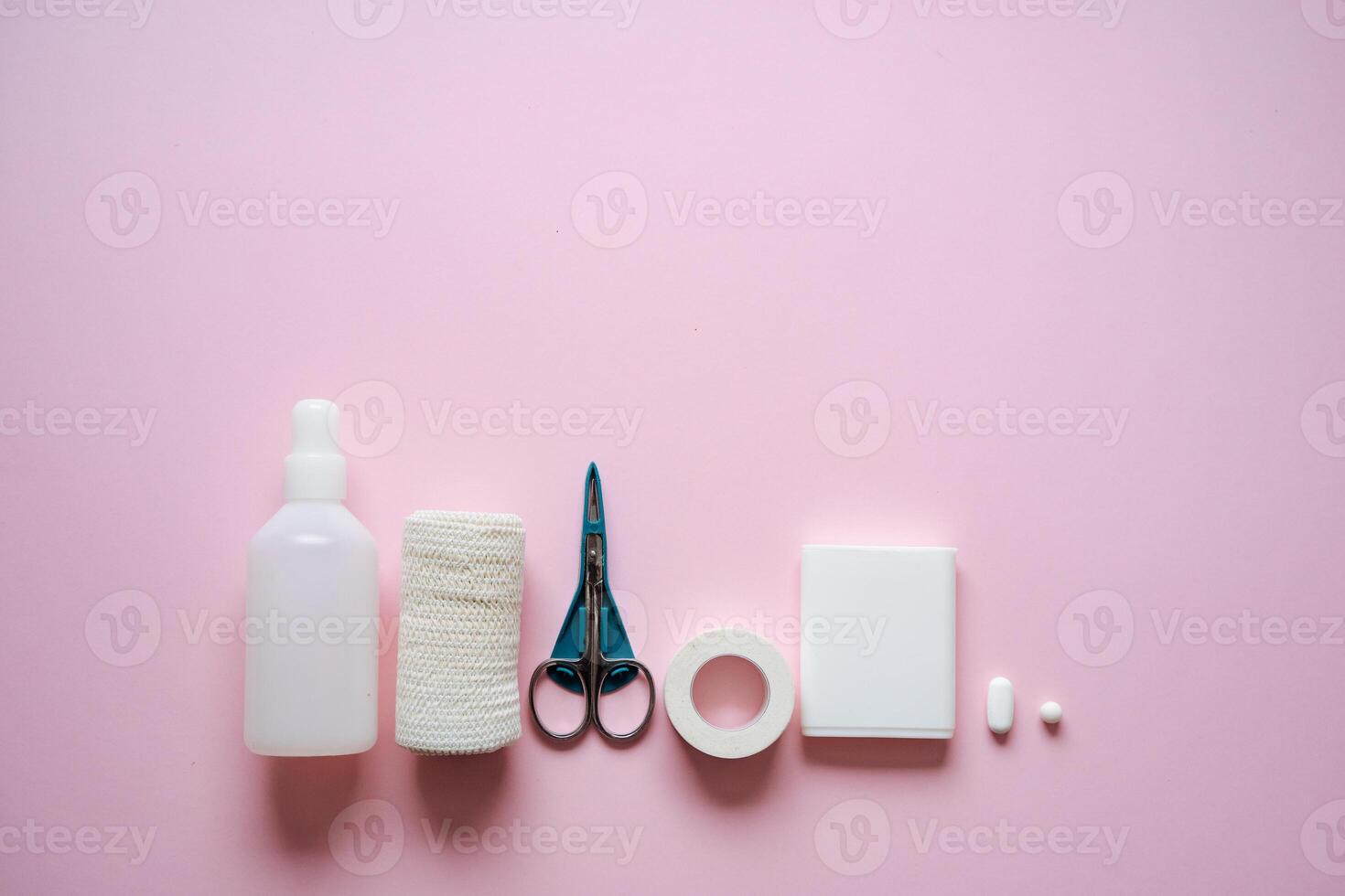 First Aid Supplies and Essential Tools Arranged Neatly on a Soft Pink Background Vital Components for Ensuring Health and Safety in Various Emergency Situations and Incidents photo