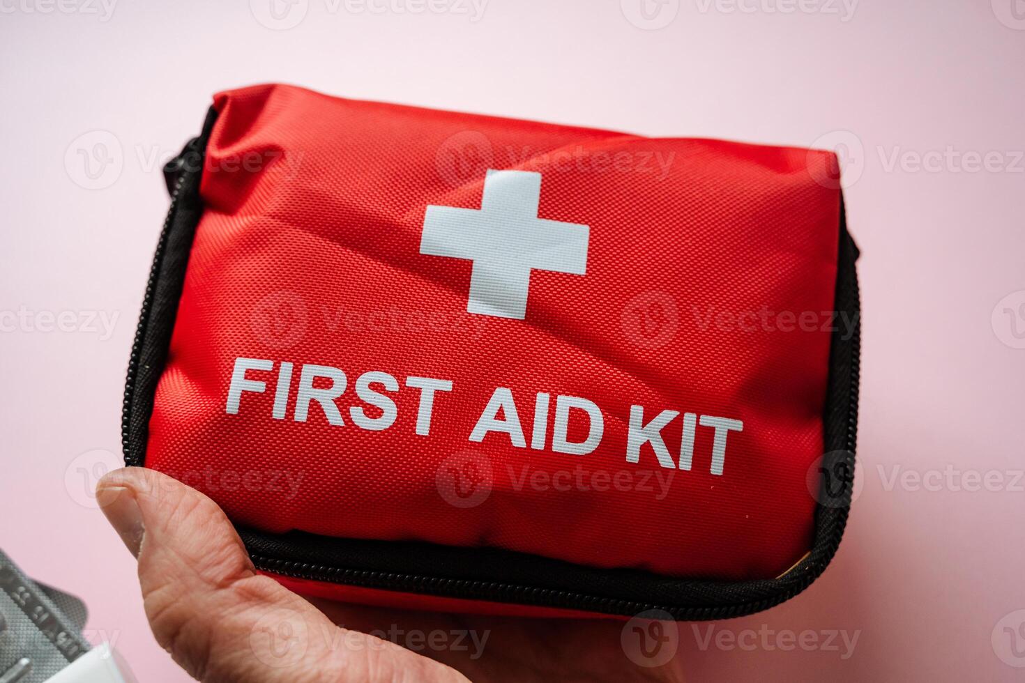 This Compact Red First Aid Kit is carefully designed for emergencies and travel, containing essential safety supplies necessary for addressing various medical situations photo