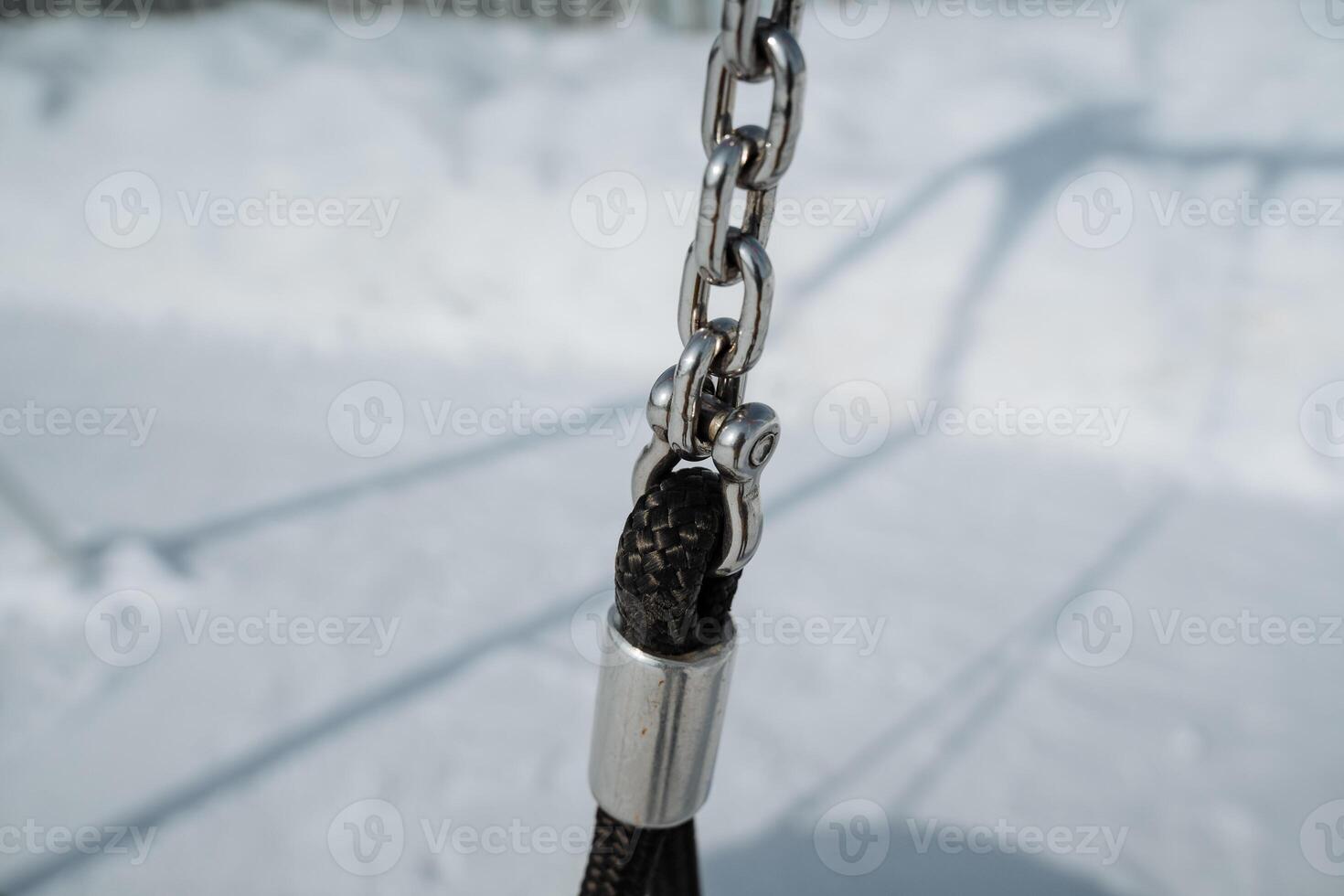 CloseUp of Chain Link and Swing Attachment in Snowy Landscape photo