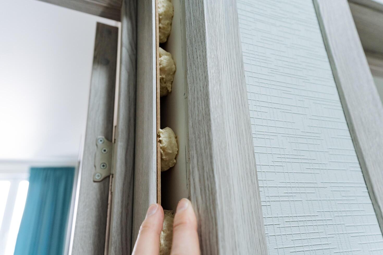 An individual showcases impressive strength and unwavering stability as they confidently grip a sturdy piece of wood, emphasizing their determination and sharp focus on the resilient plank photo