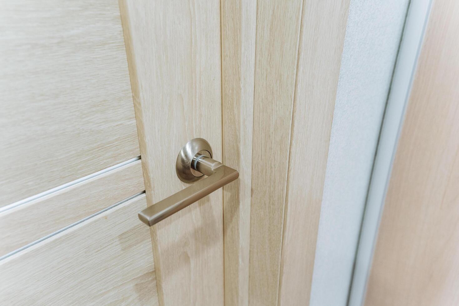 This closeup image showcases a stunning door handle on an elegant wooden door, highlighting its intricate design and exceptional craftsmanship, making it truly remarkable photo