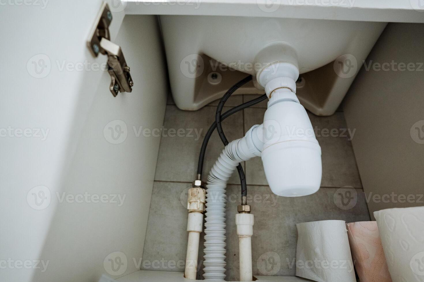 The bathroom sink has a drain pipe connected to the plumbing system, ensuring efficient wastewater disposal and promoting cleanliness, hygiene, and health in your household photo