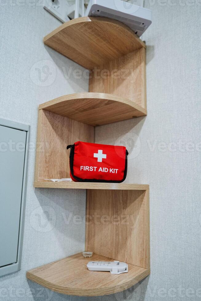 A wellequipped first aid kit is meticulously organized on a sturdy and durable hardwood shelf, which beautifully showcases the rich stain and glossy varnish finish of the polished plywood photo