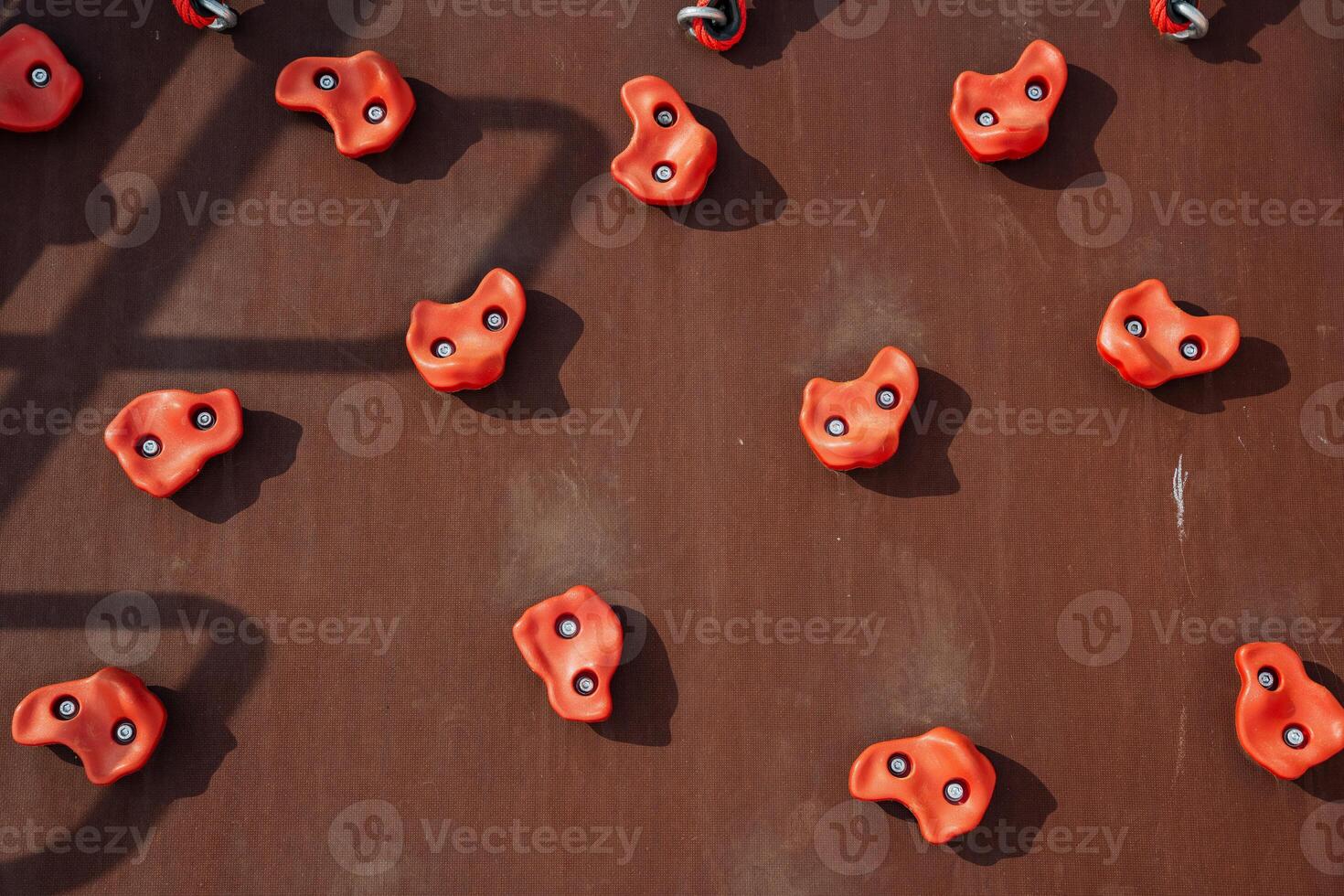 Colorful climbing wall holds on a textured surface enhance indoor rock climbing enjoyment, fitness, safety, and coordination for all participants in this thrilling activity photo