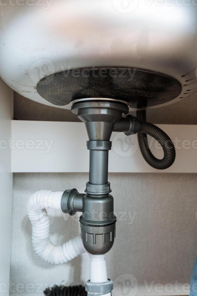This elegantly designed sink features a stylishly hanging drain pipe from its underside, showcasing a vital component that ensures efficient wastewater removal in any bathroom setting photo