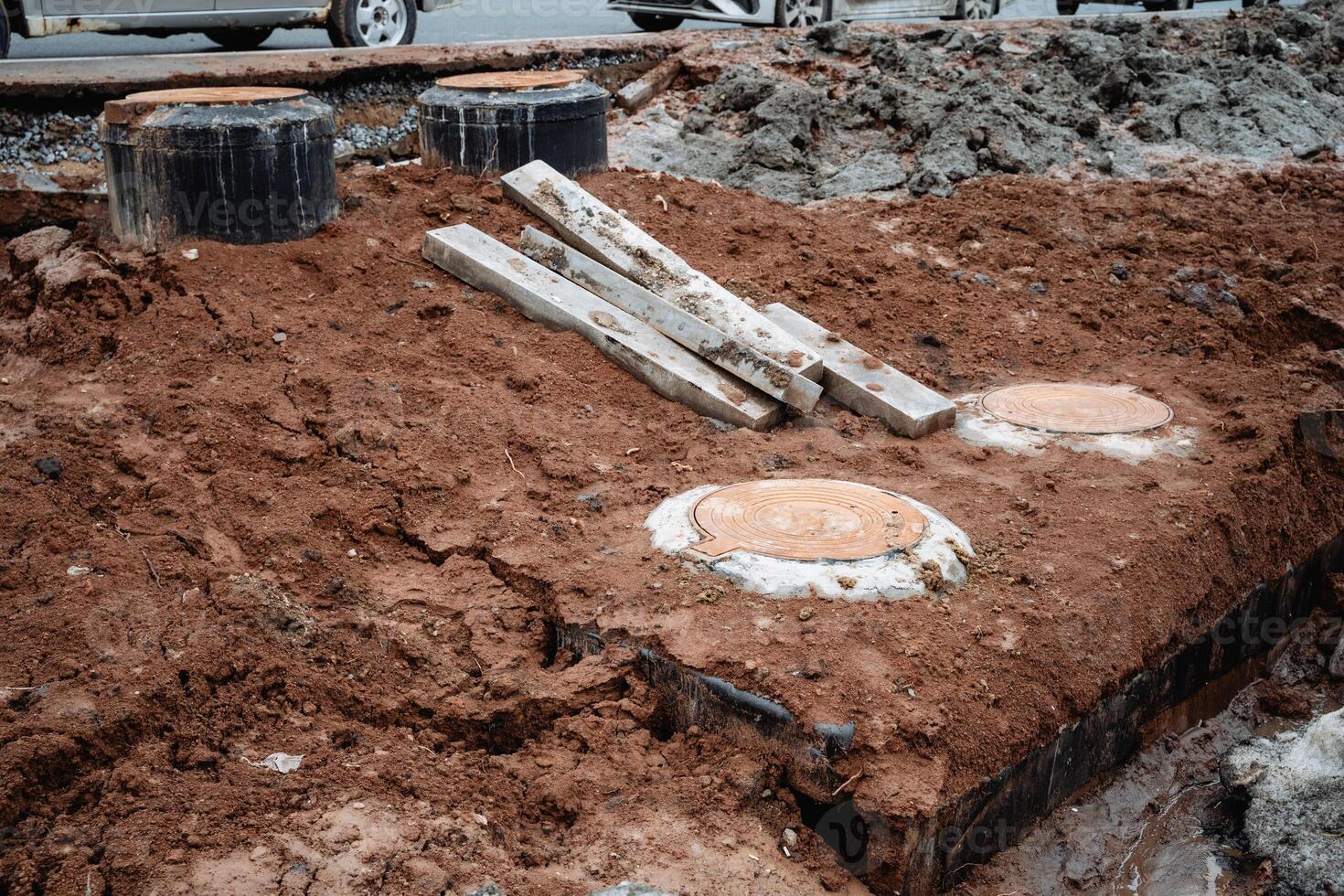 A sizable pile of dirt, mixed with several pieces of wood and other materials, can be seen at the construction site, indicating ongoing geological activity related to the project photo