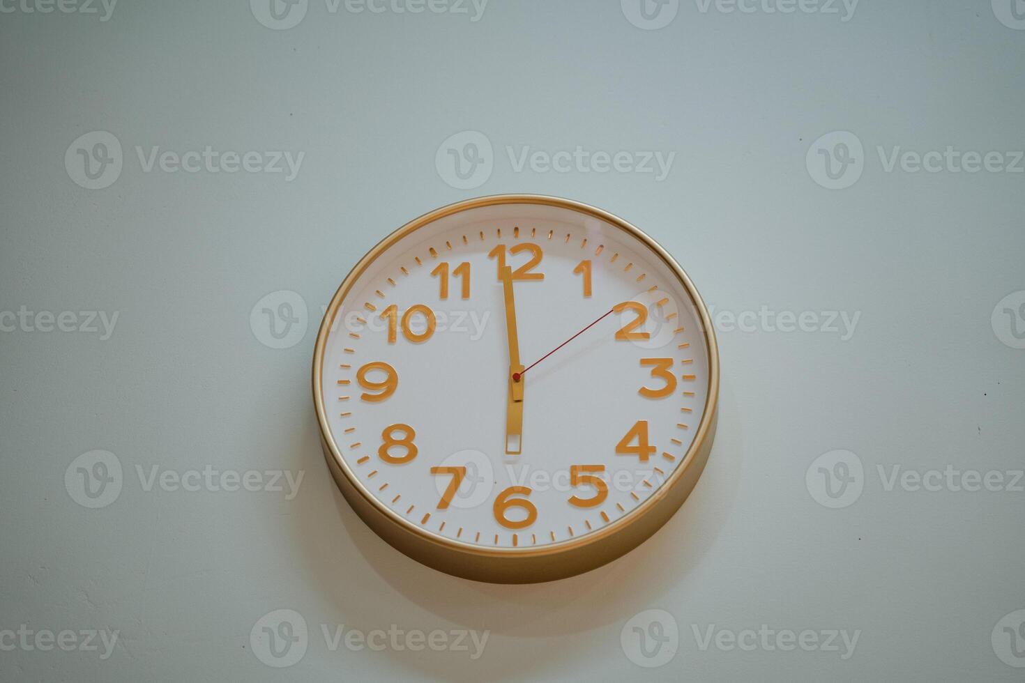 On a pristine white wall, a classic clock prominently displays the time as 500, clearly indicating a peaceful early evening or late afternoon moment perfect for relaxation photo