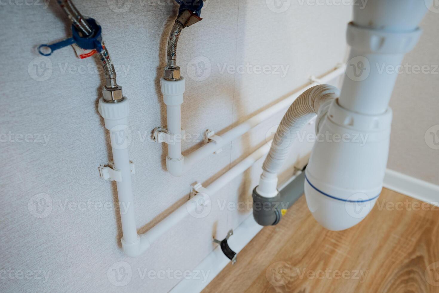 This closeup image highlights the intricate features of a bathroom sinks plumbing pipe, showcasing typical plumbing and electrical components found in such installations photo