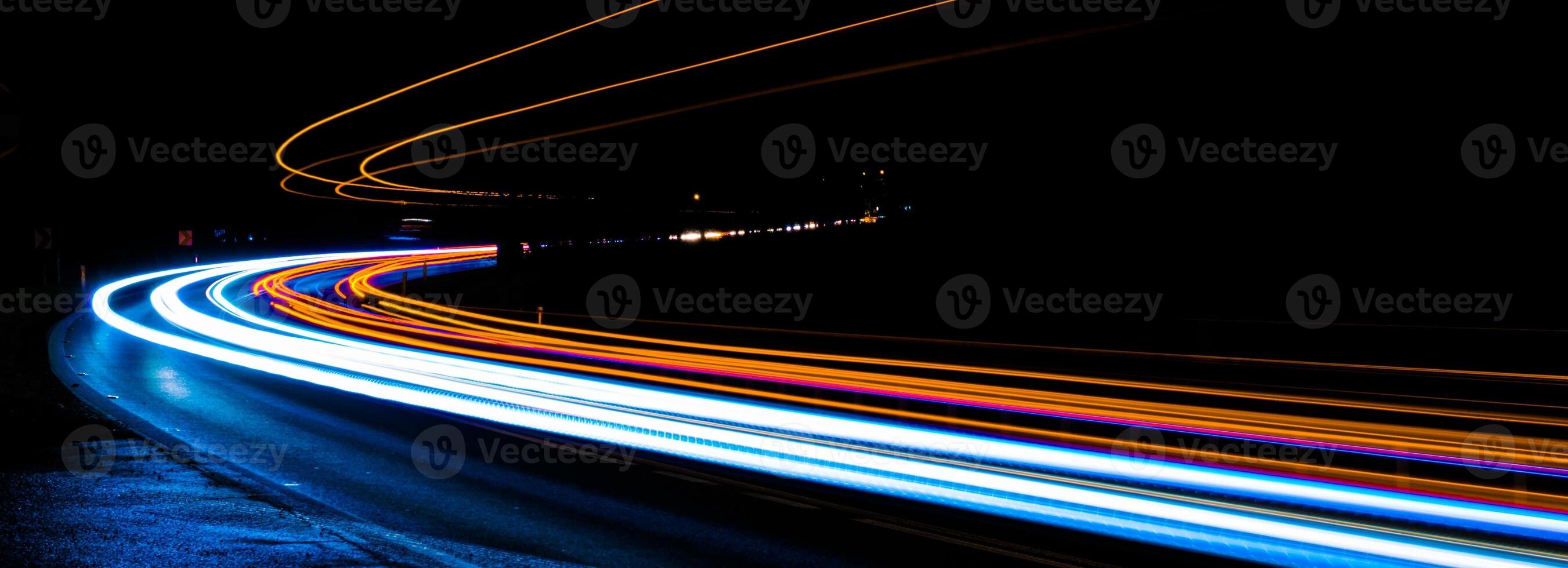 orange and blue car lights at night. photo