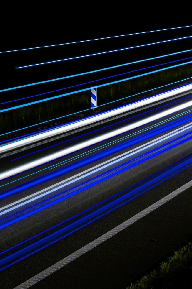 blue car lights at night. light line photo