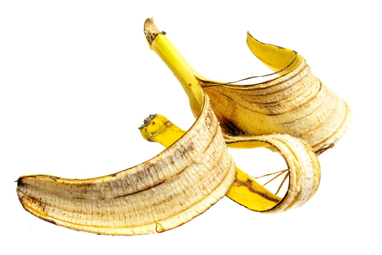 yellow banana peel on a white isolated background. photo