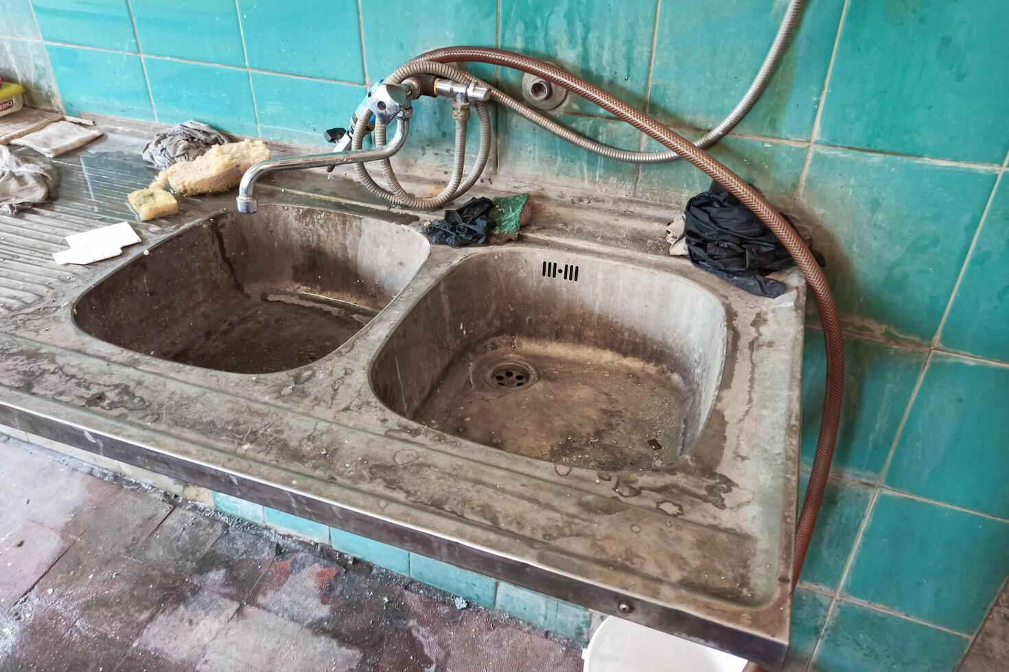 old rusty sink on a background of blue tiles photo