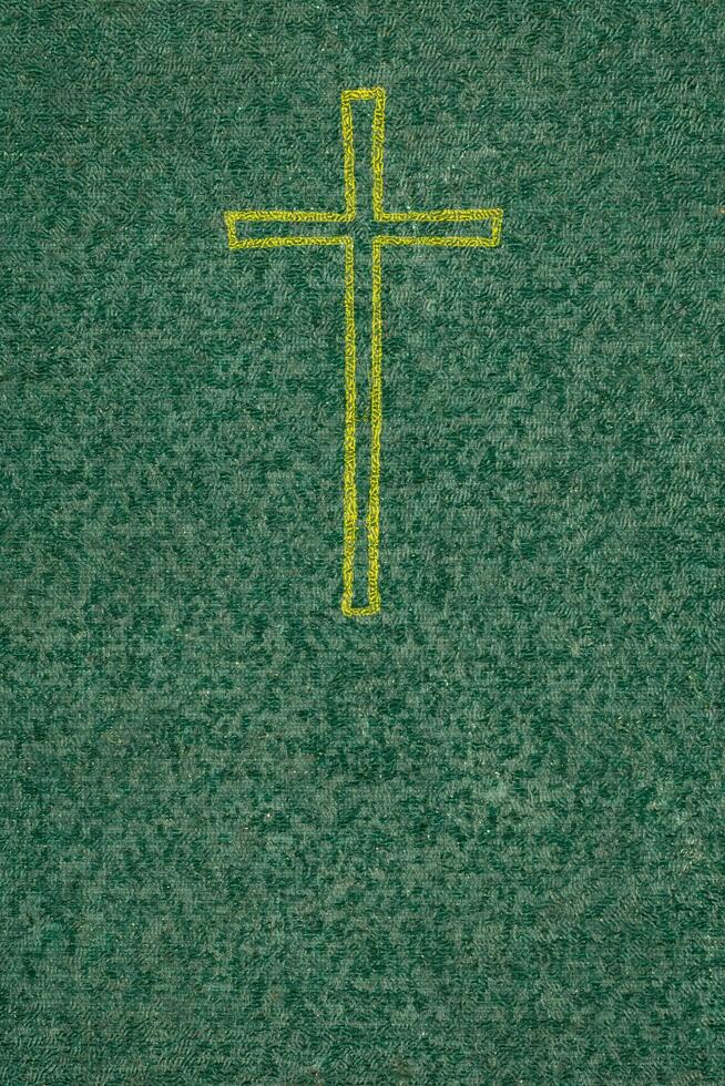 gold cross on a green background with a visible texture photo