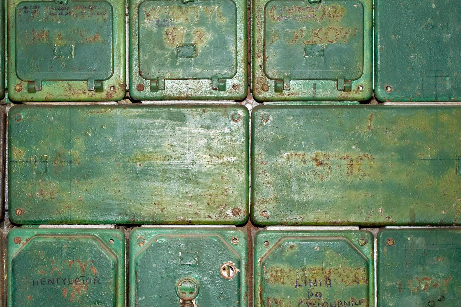 old power switchboard painted green on a white wall. photo