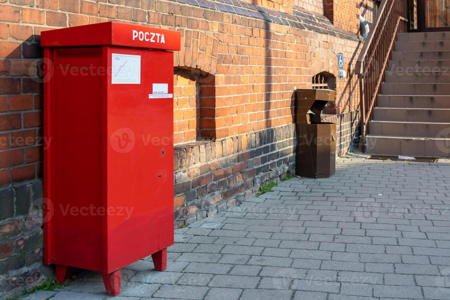 red mailbox on a red brick wall photo