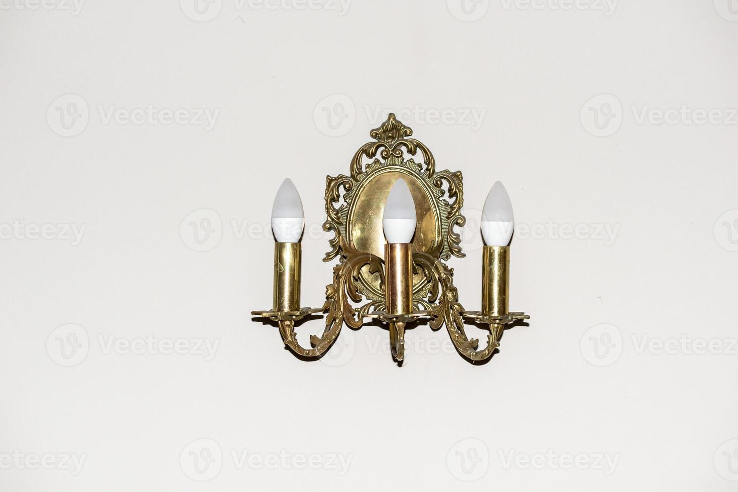 golden lamp on the background of a white wall photo
