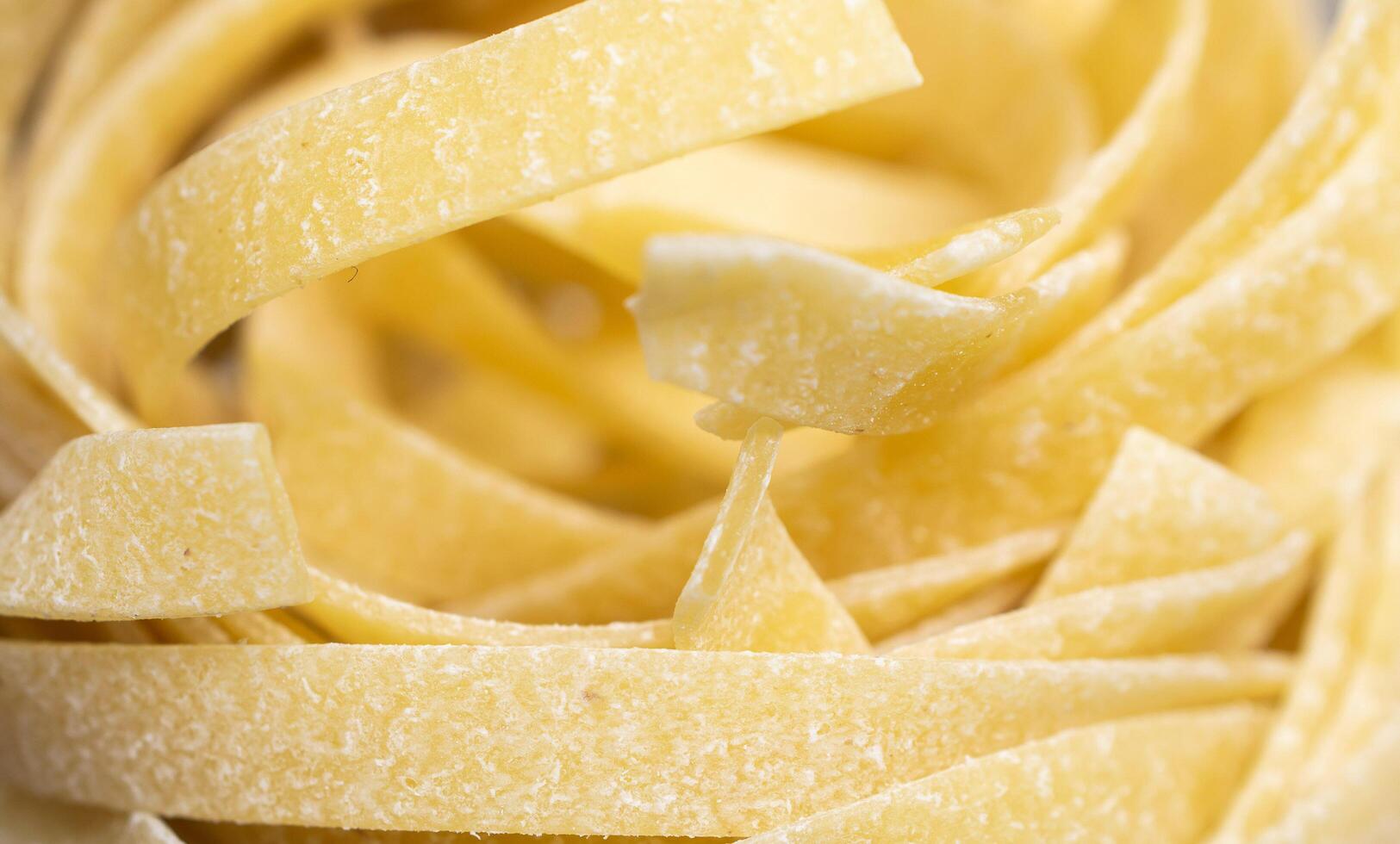 yellow pasta with visible details. background or texture photo