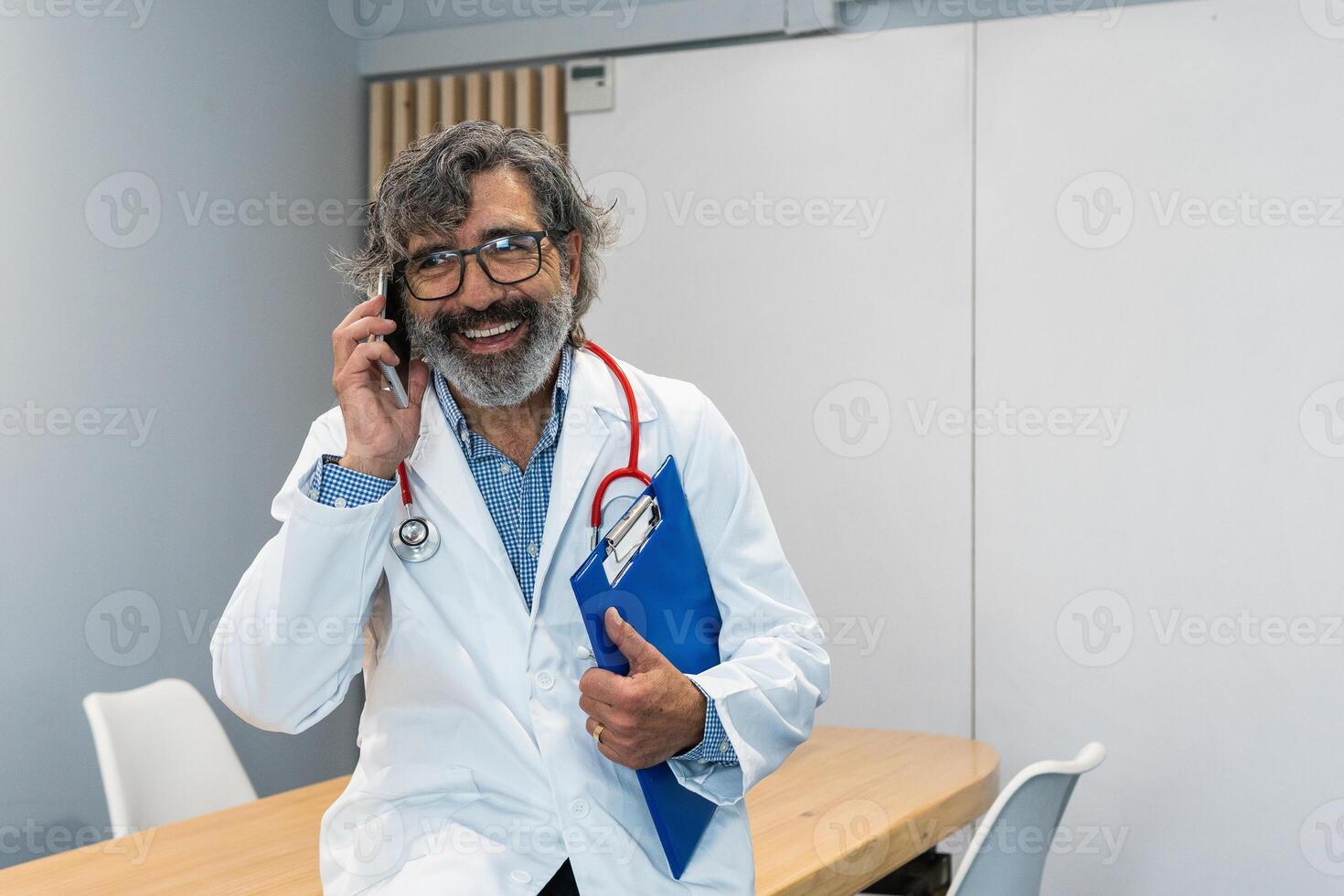 Senior doctor using smartphone in medical office photo