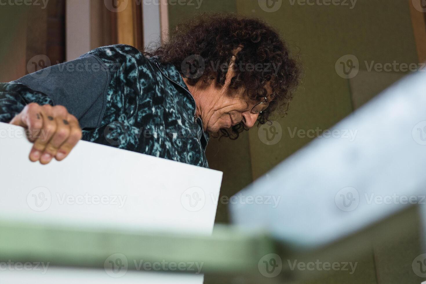 Carpenter working with plywood in workshop photo