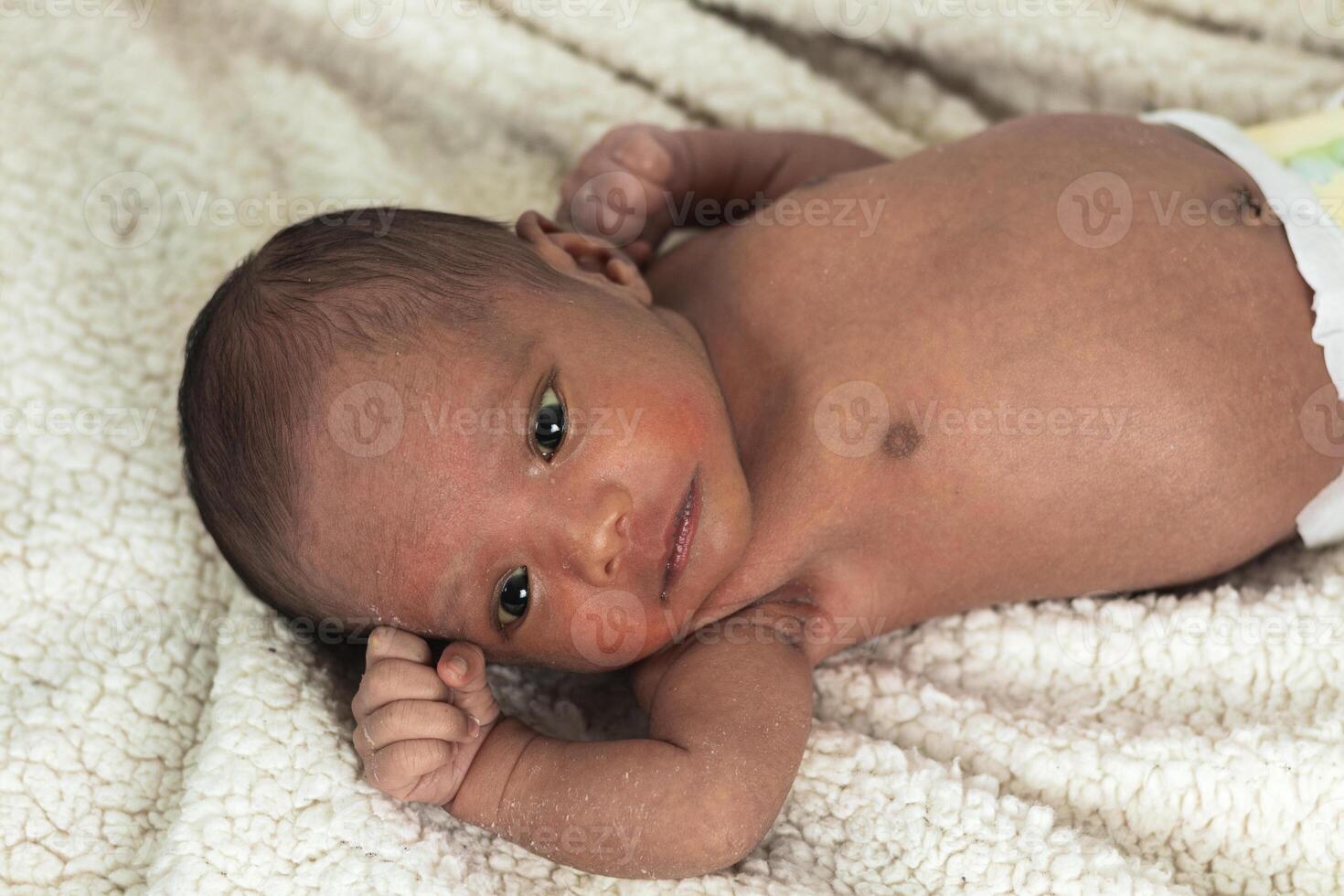 Newborn baby on soft blanket photo