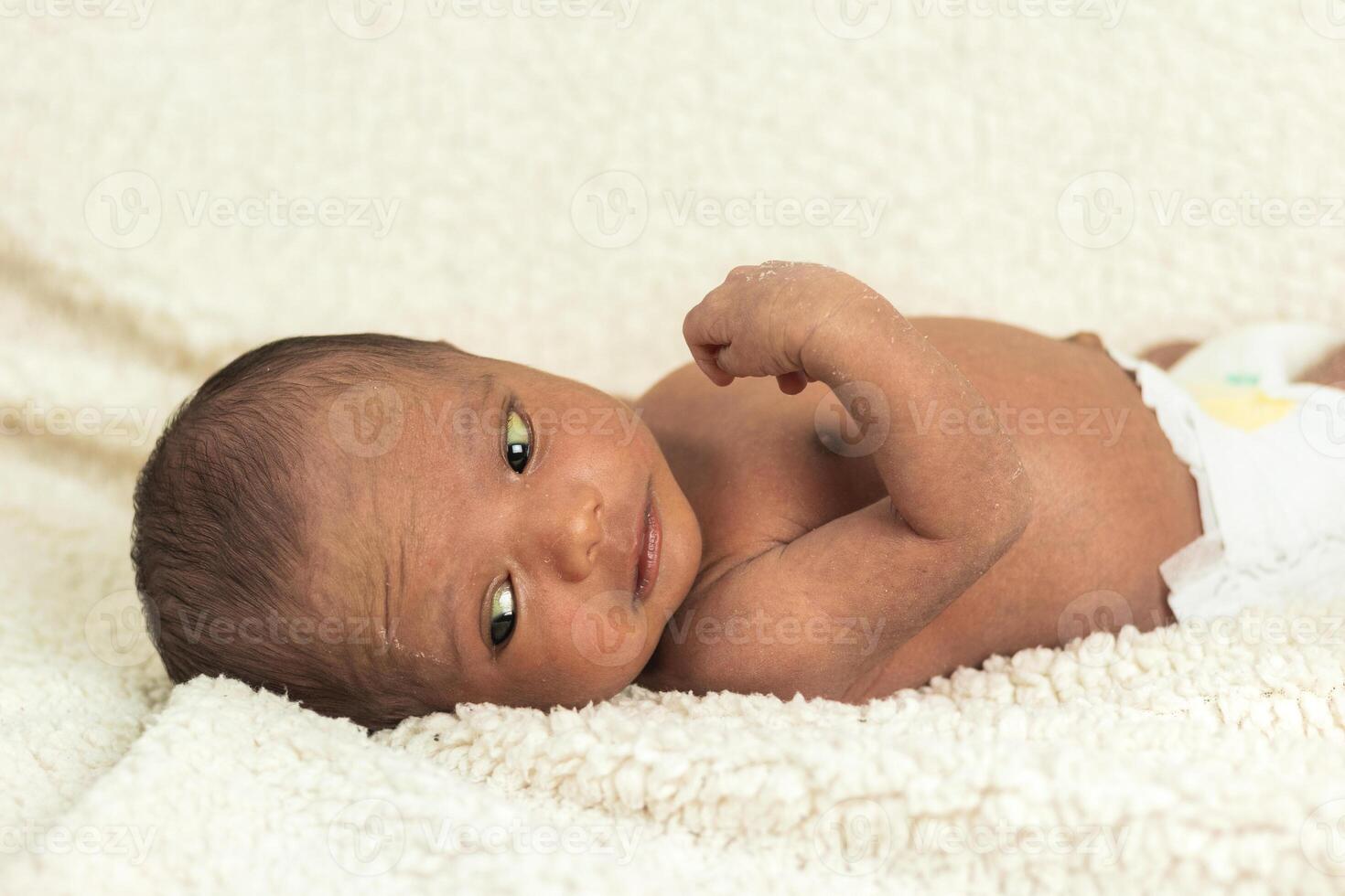 Newborn baby on soft blanket photo