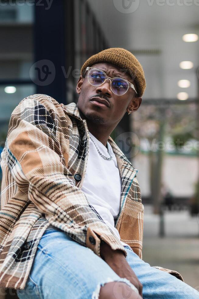 Stylish African American man resting on street photo