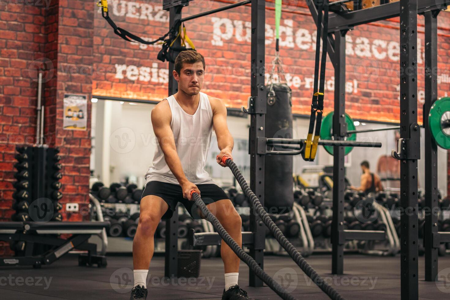 A man is using a rope in a gym photo