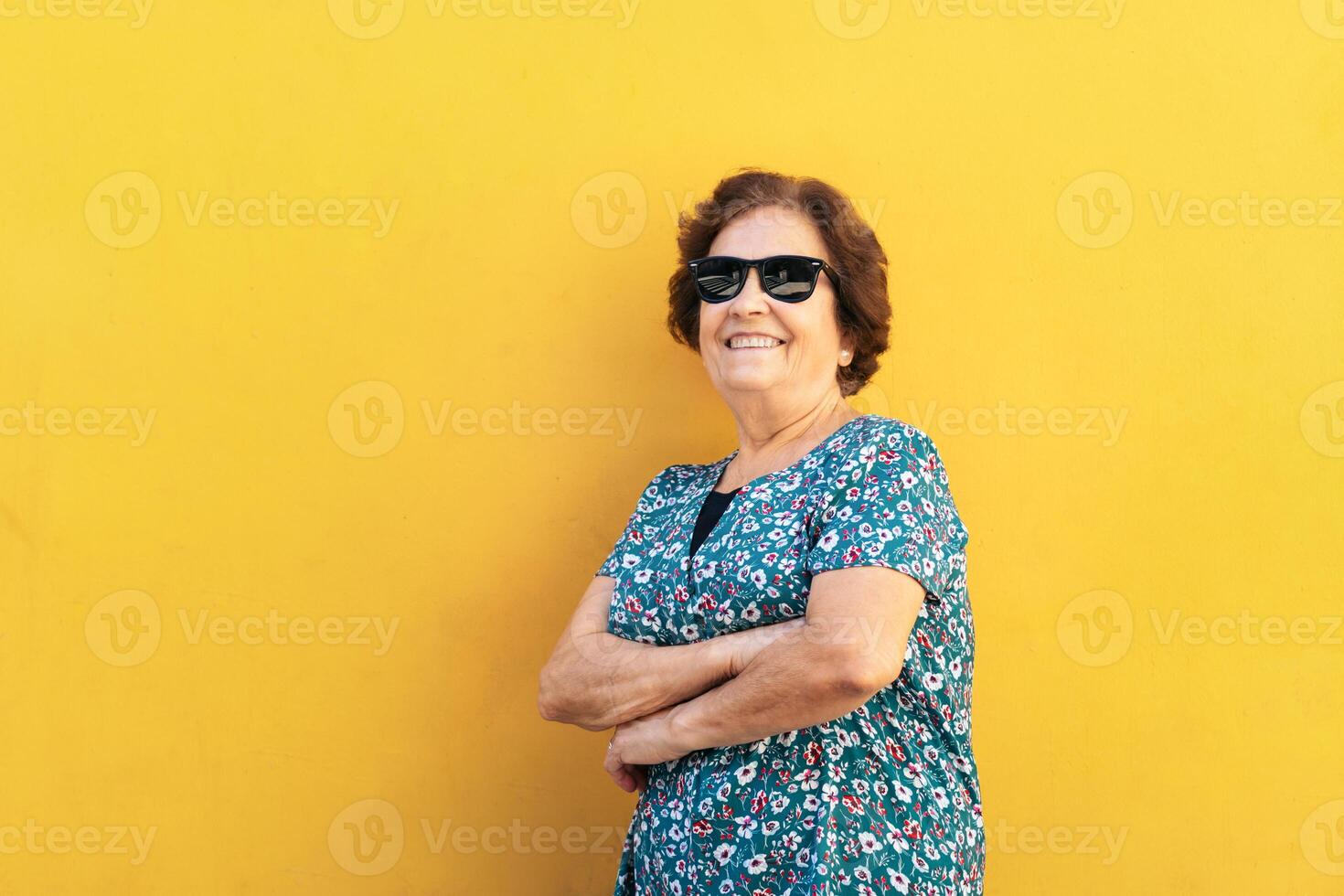 Stylish old woman in sunglasses and colorful clothes photo