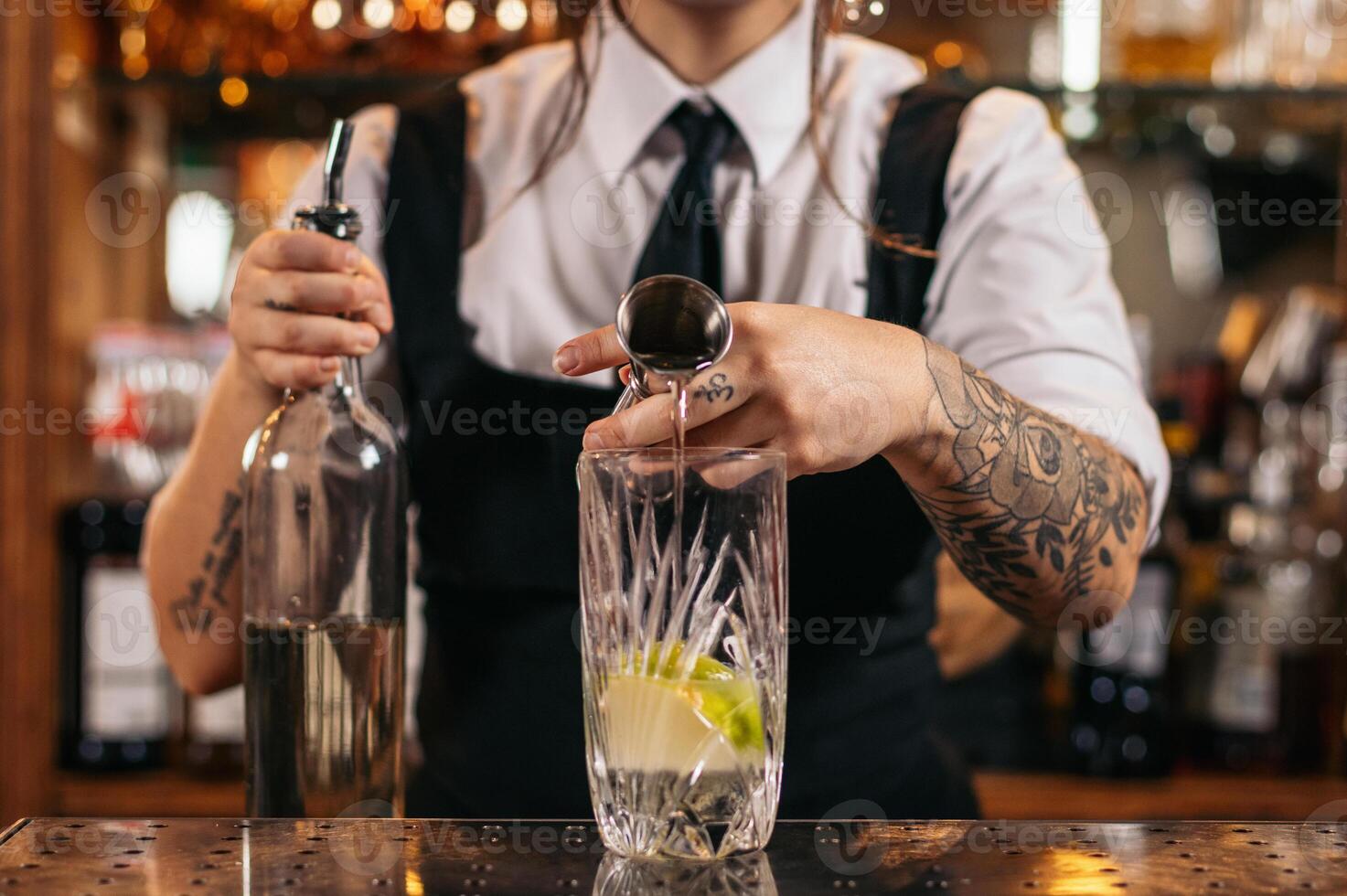 Female bartender preparing a cocktail in a traditional cocktail bar photo
