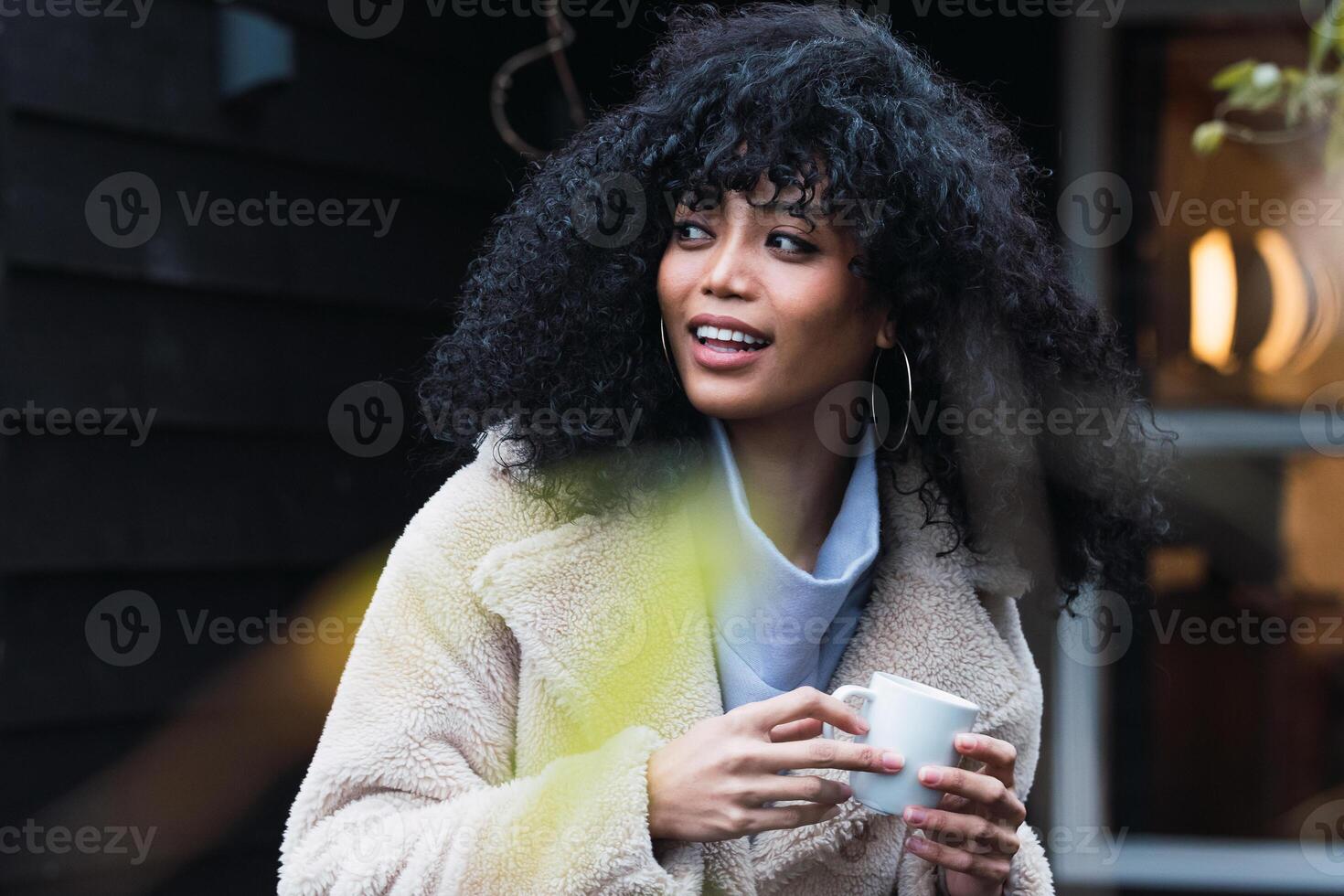 Smiling black woman with cup of coffee photo